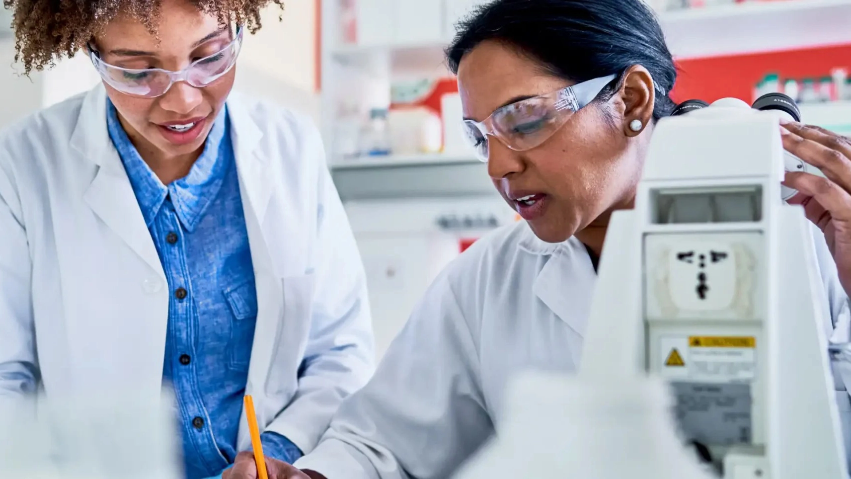 Scientists performing pharmaceutical quality control and analytical testing in a laboratory environment.